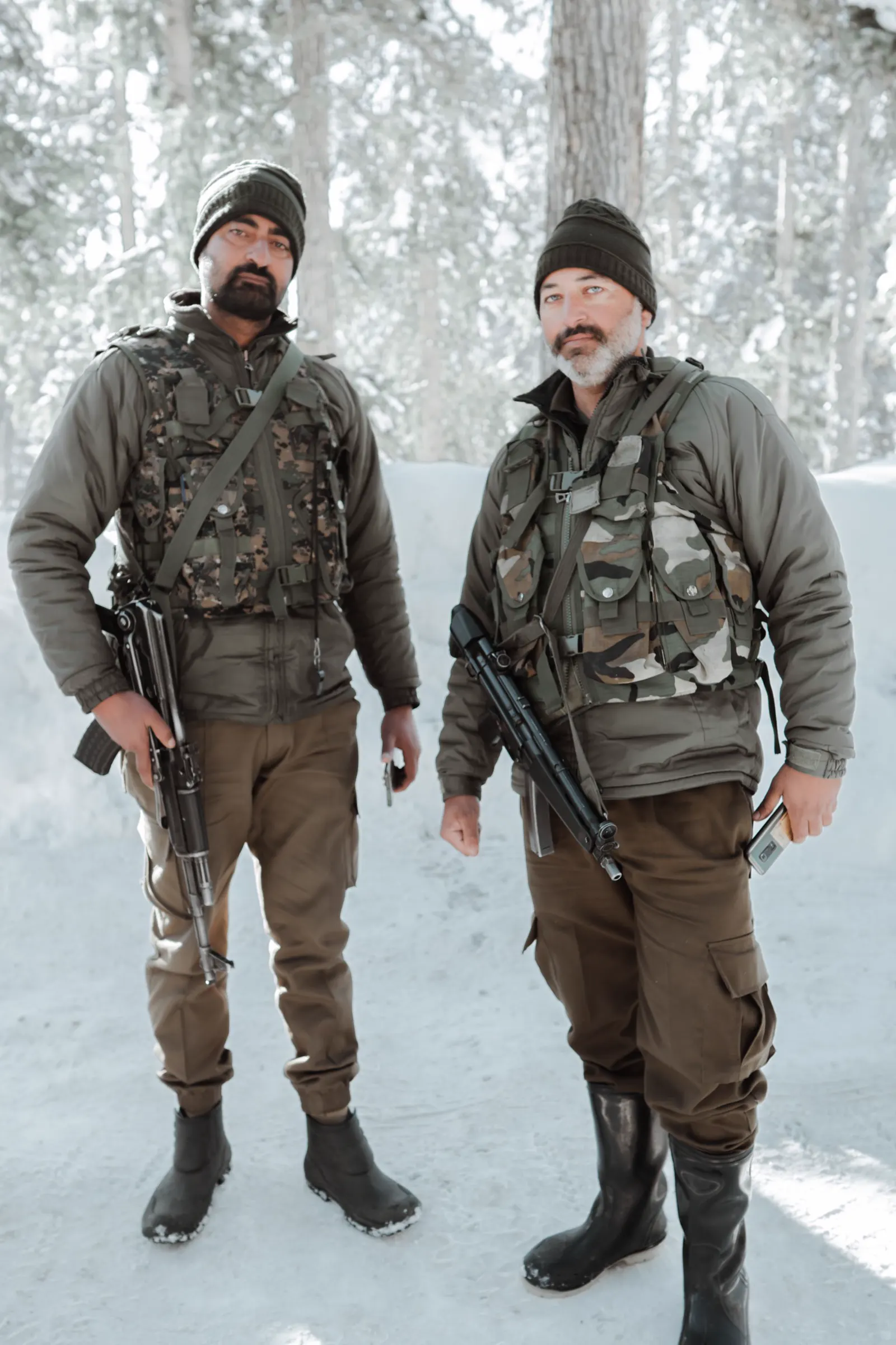 Soldiers in winter gear in a snowy forest