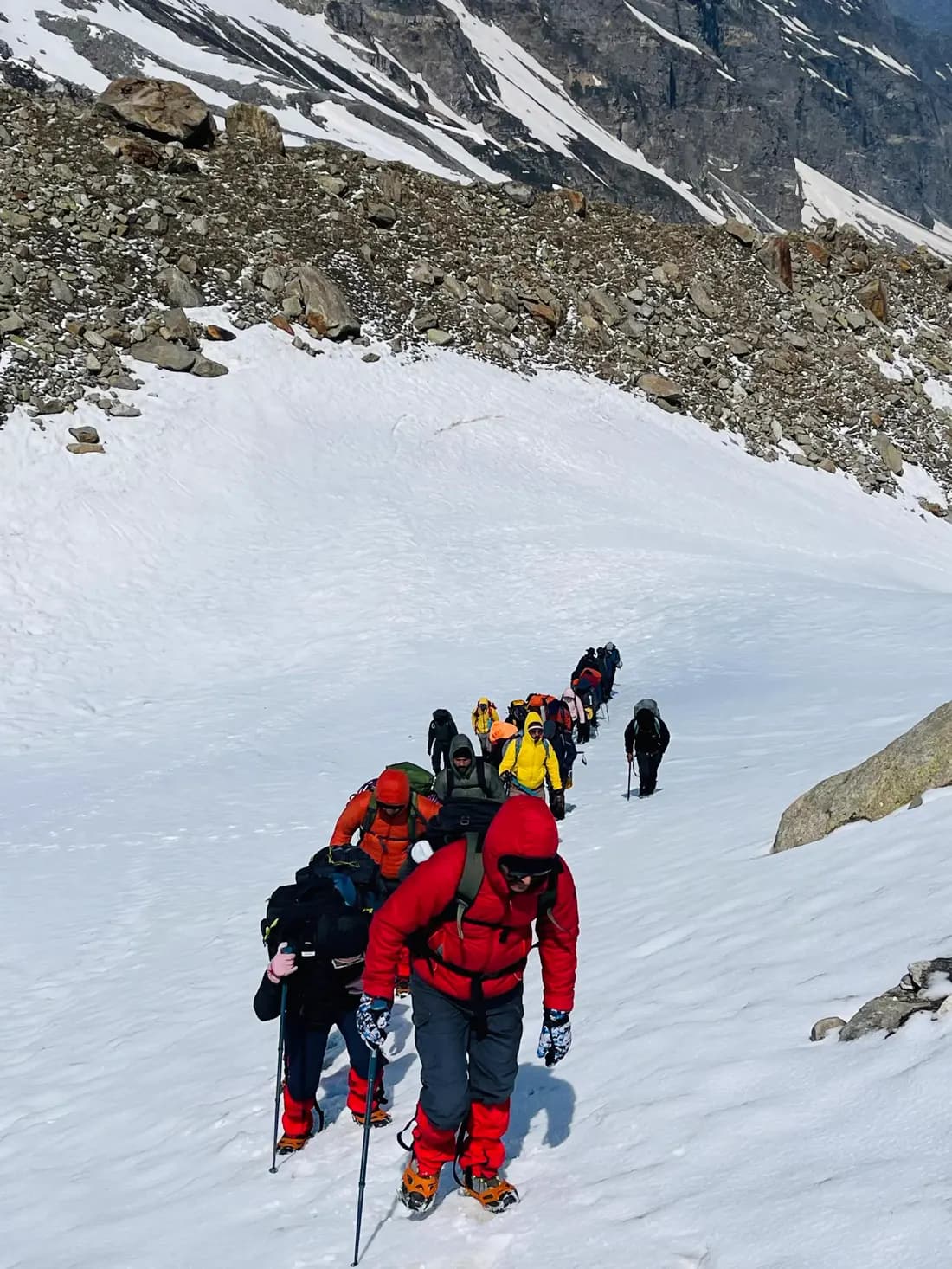 Trekkers climbing a snowy Himalayan trail